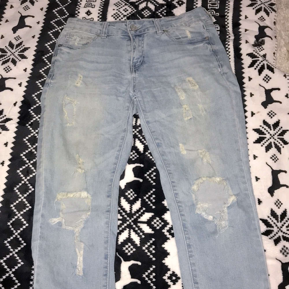 ripped jeans in front. light blue jeans
